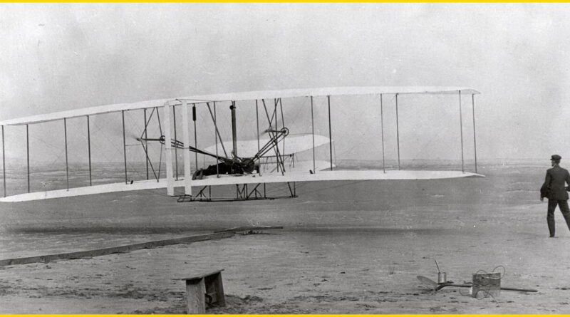 The first successful powered, controlled flight by the Wright Brothers at Kitty Hawk, North Carolina, on December 17, 1903. The Wright Flyer lifts off the ground with Orville Wright at the controls and Wilbur Wright running alongside.